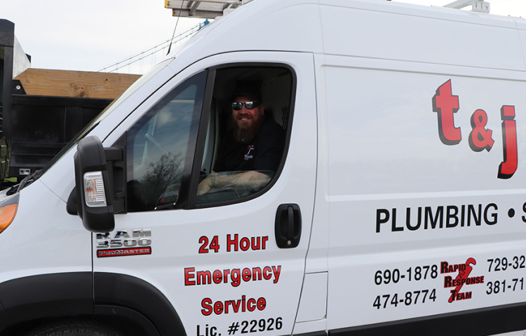 Plumber in Toledo Ohio looks out of the door of his plumbing toledo, Ohio van